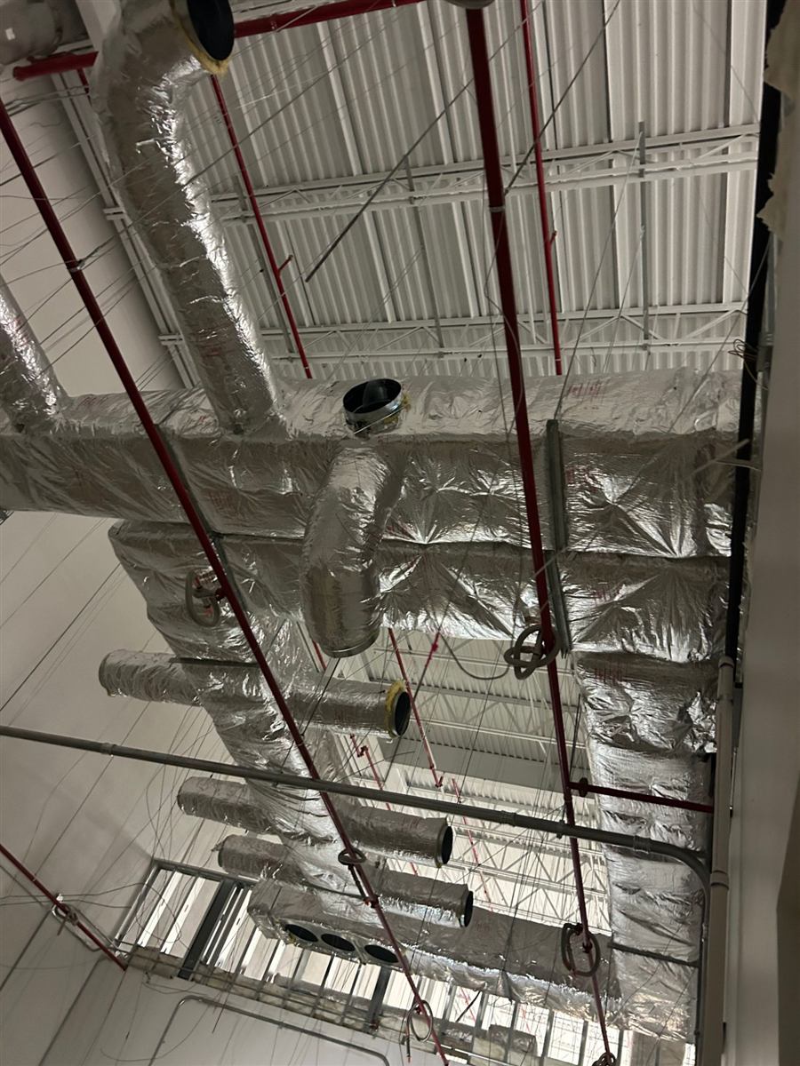 Insulated ductwork mains and branch runs at the ceiling